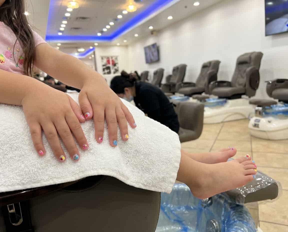 Child receiving professional manicure and pedicure at LeVon Nail Lounge.